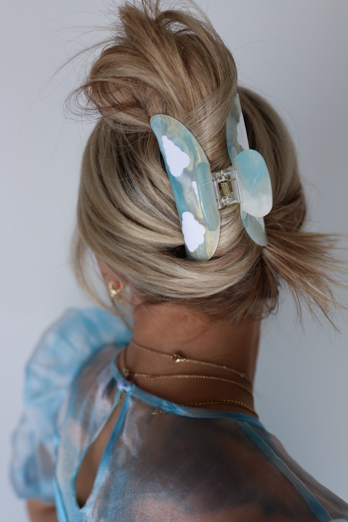 Light blue translucent hair claw clip with white flower cloud accents