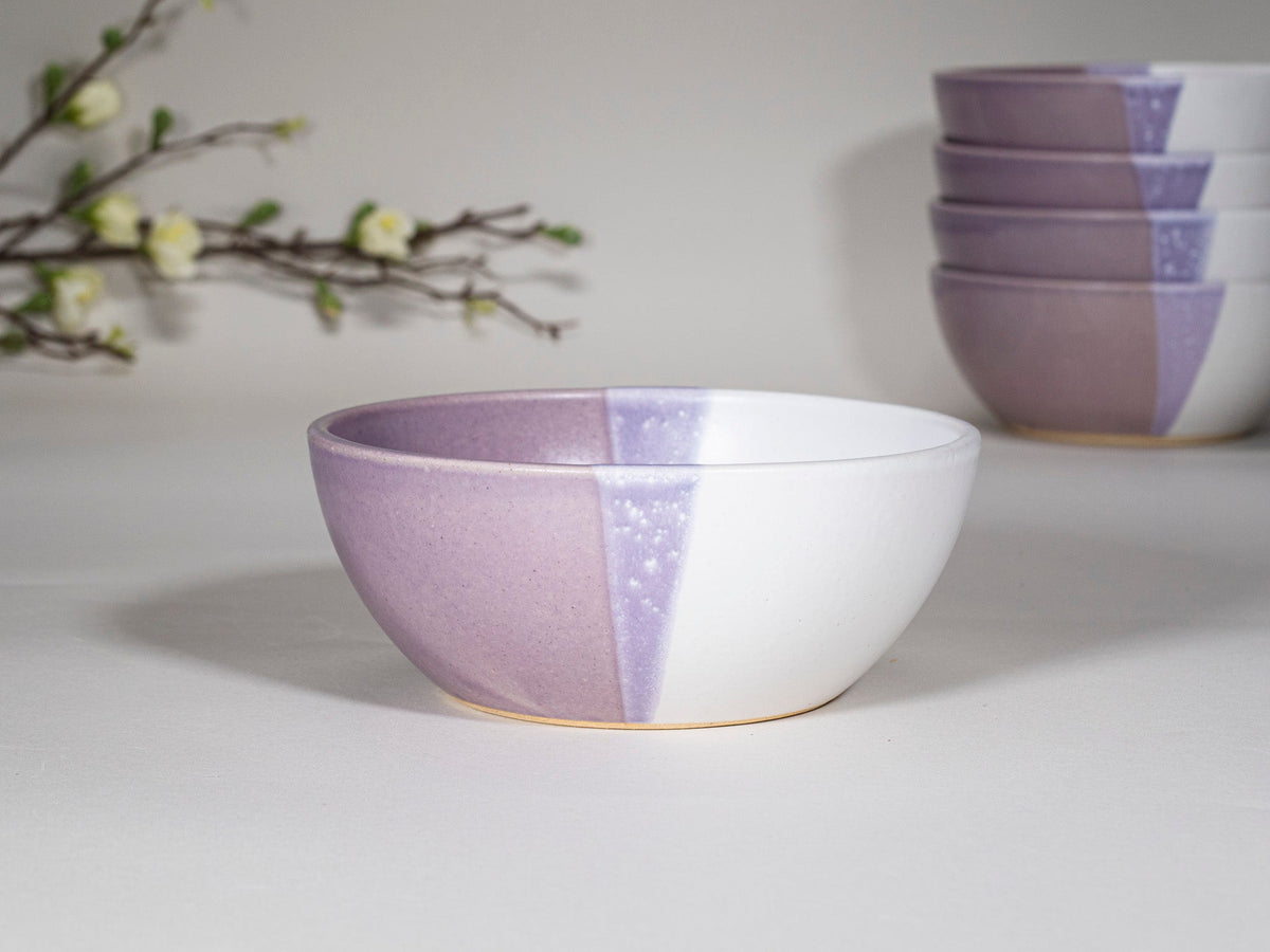 Purple and white stoneware soup bowl with speckled stripe, centered view