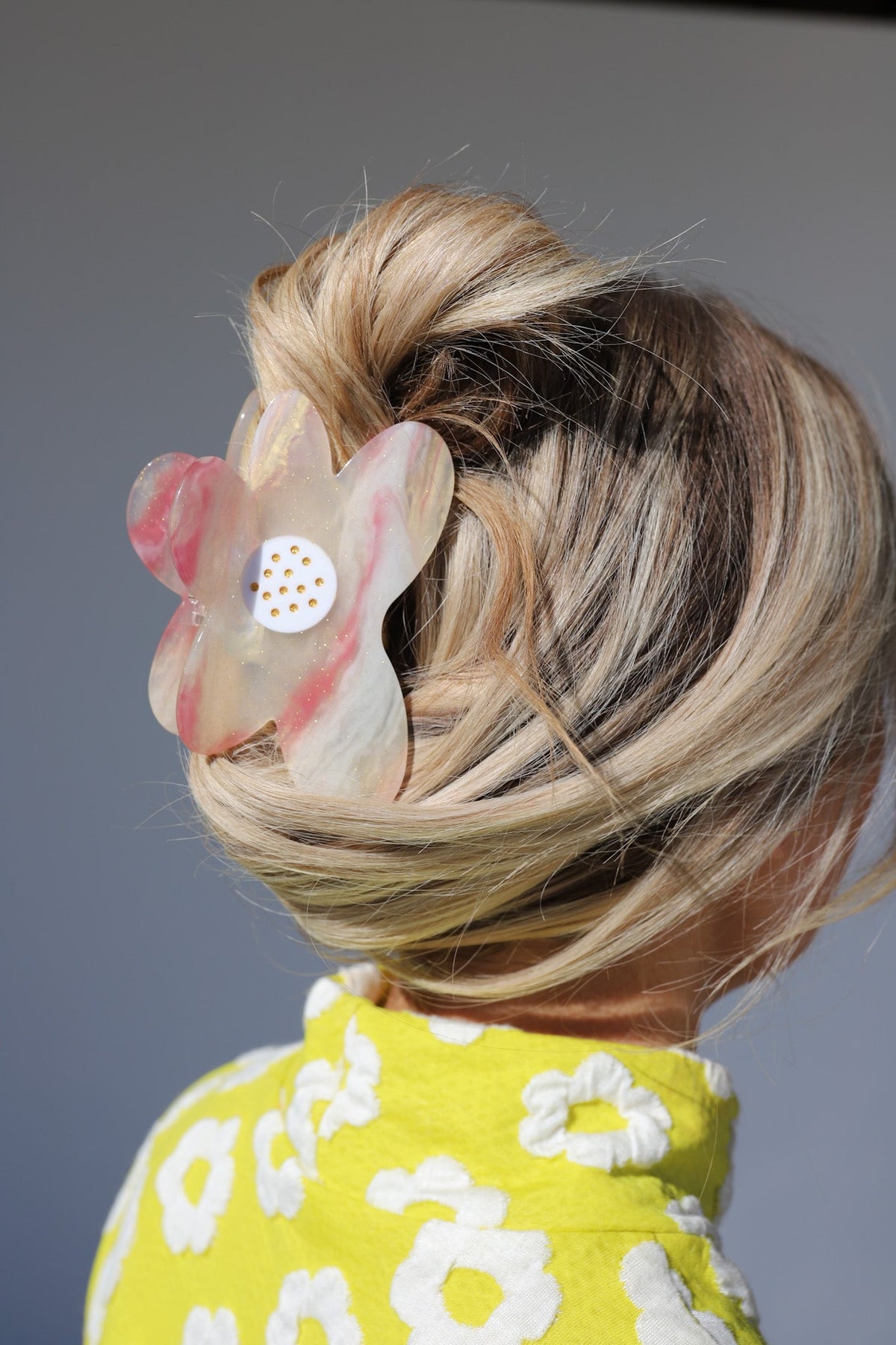 Floral color-changing hair claw clip in pink and cream on blonde hair