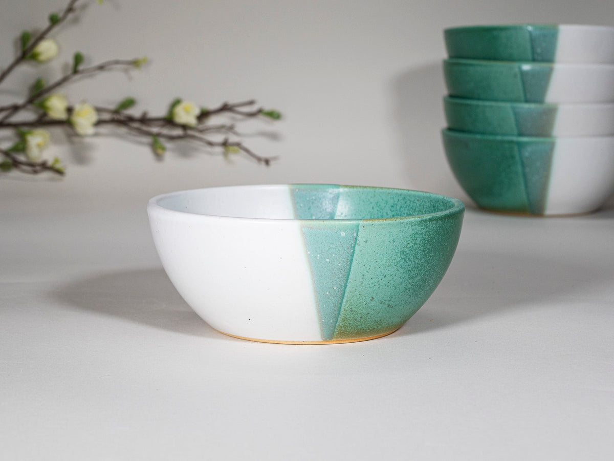 Green and white stoneware soup bowl with contrasting two-tone glaze