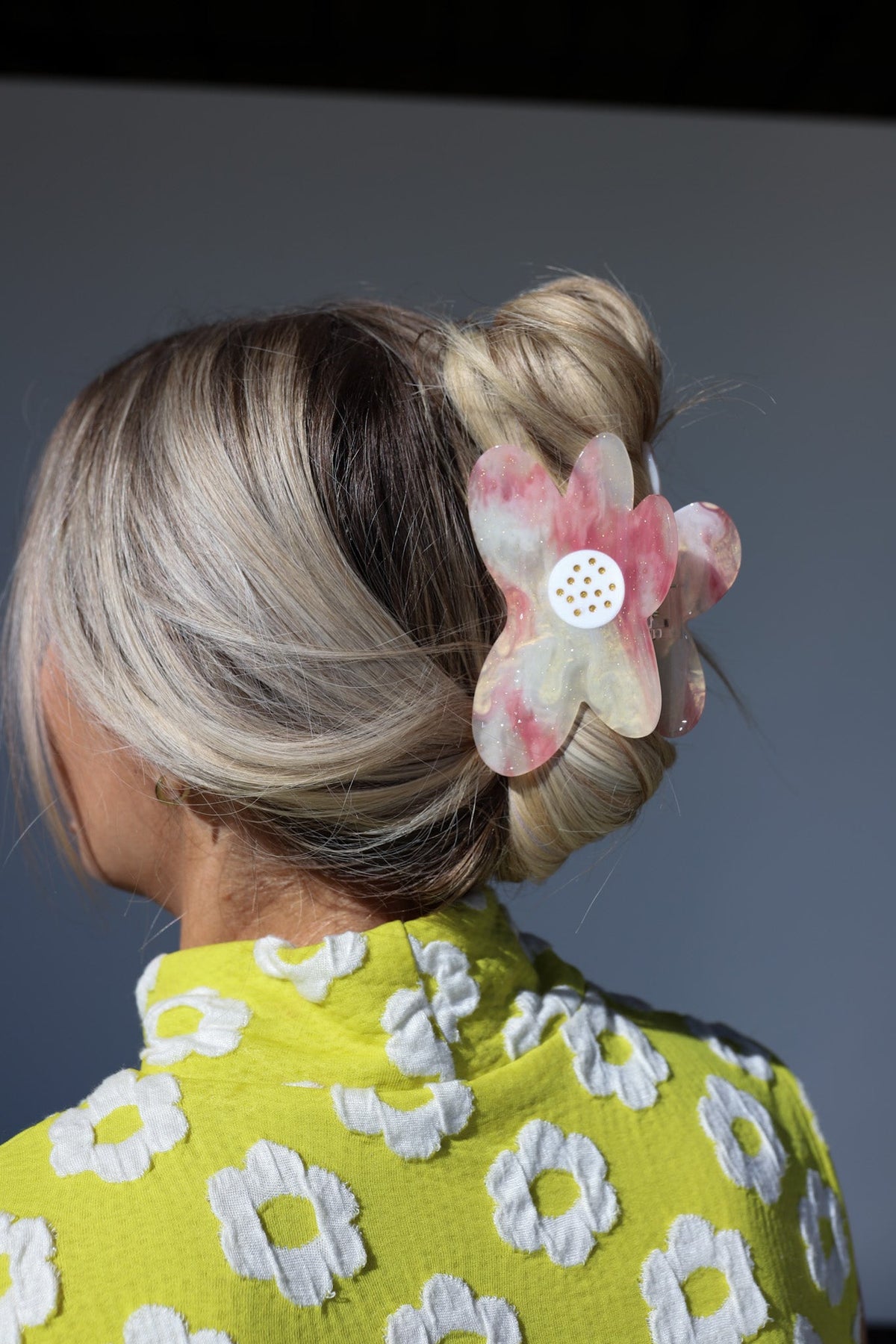 Pink-and-clear translucent floral hair claw clip with small white dot center
