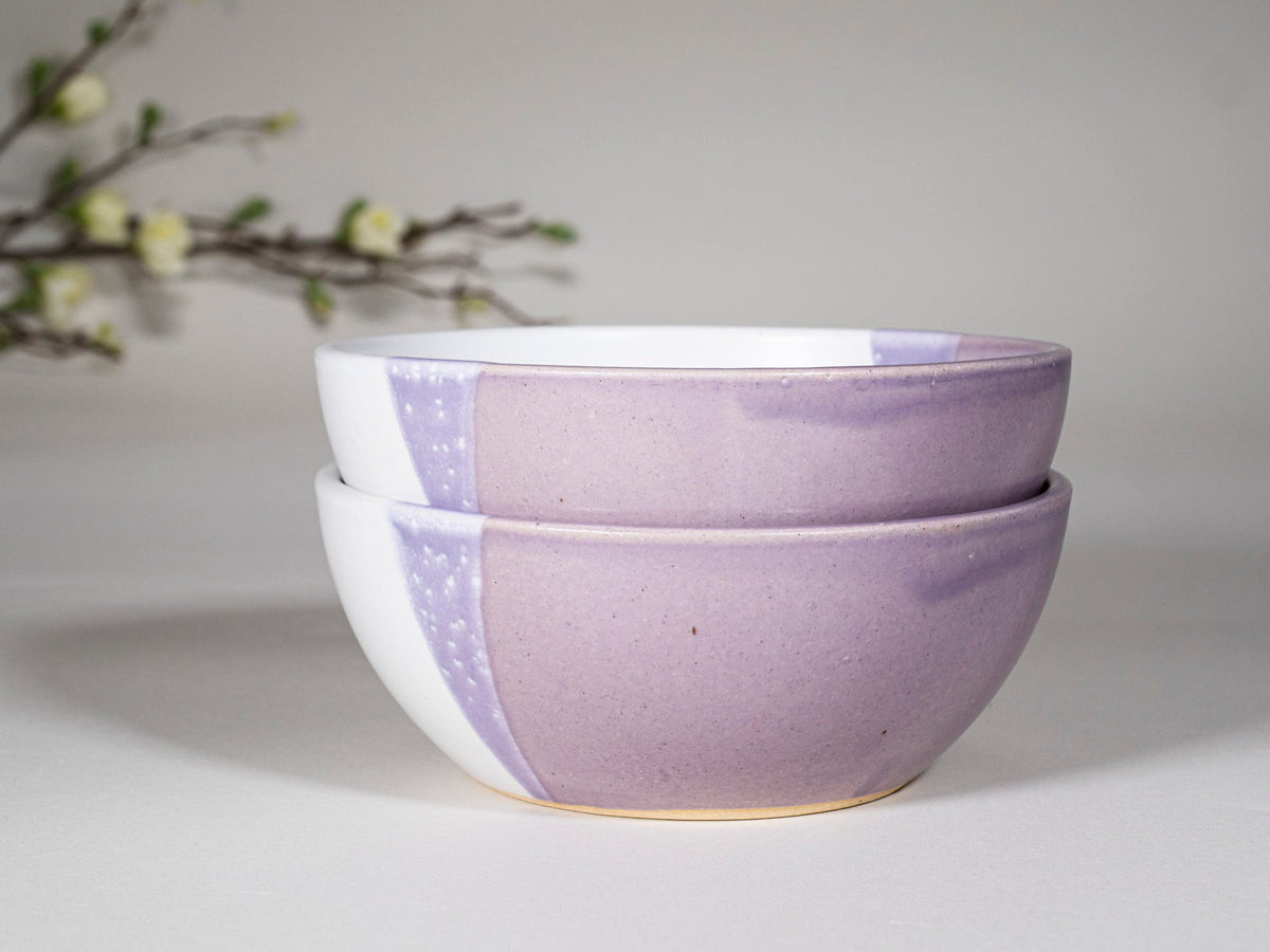 Stacked purple and white stoneware soup bowls with speckled panel and gold rim
