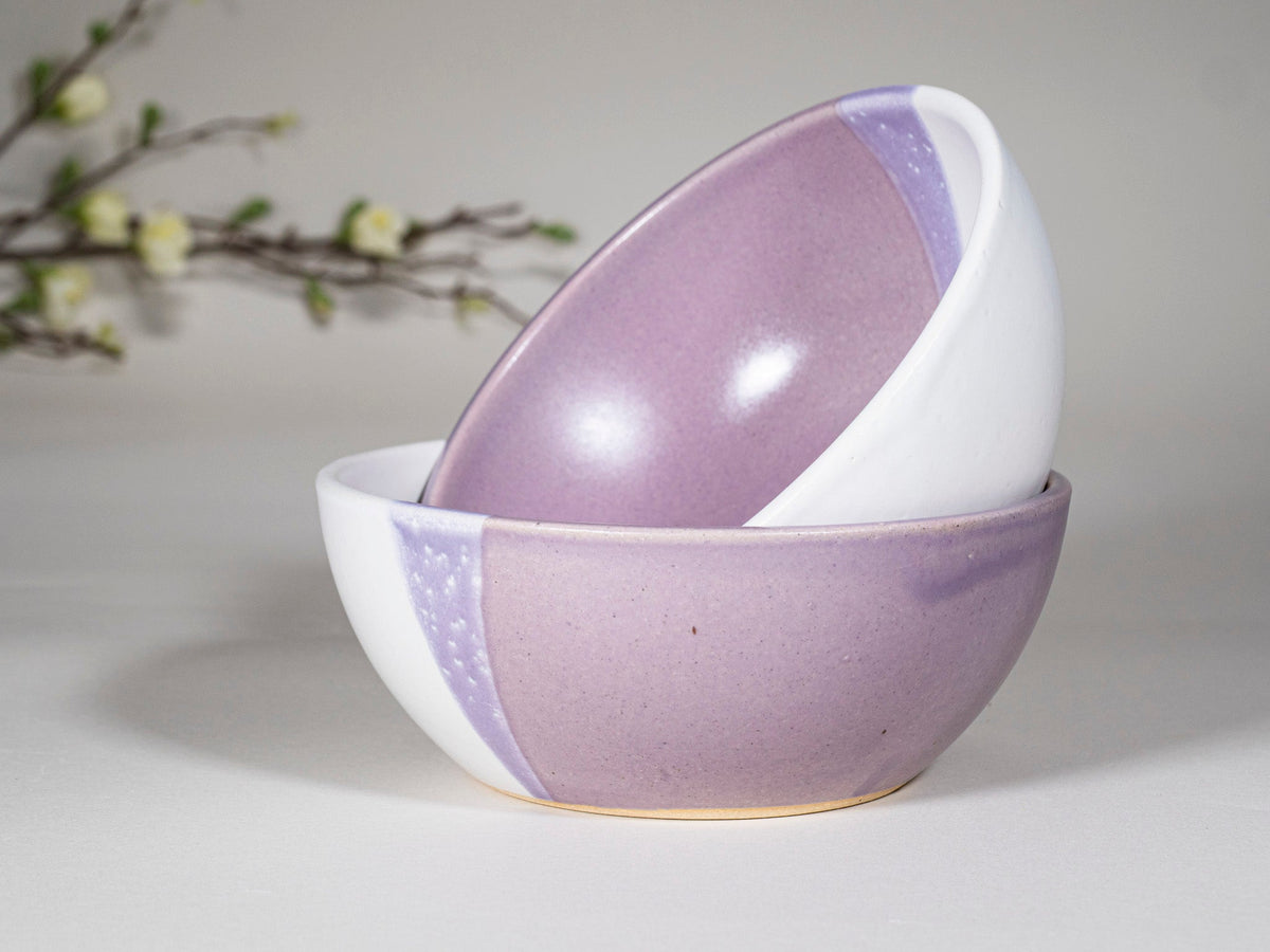 Purple and white stoneware soup bowl with speckled stripe, close angle