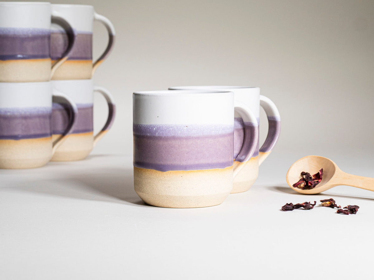 Purple and white ceramic coffee mug with handle, stoneware look, 14 oz, front view.