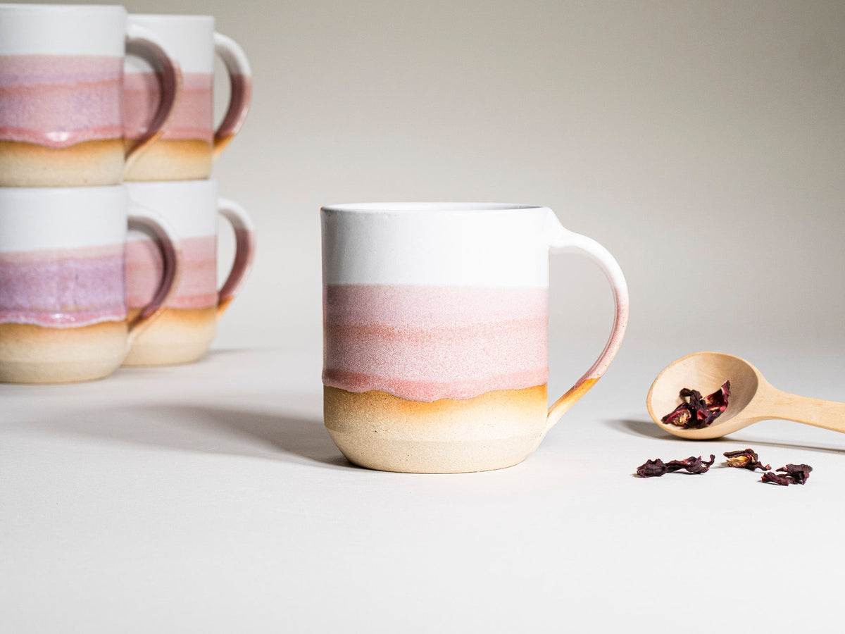 Pink and white striped ceramic coffee mug with handle, stoneware look