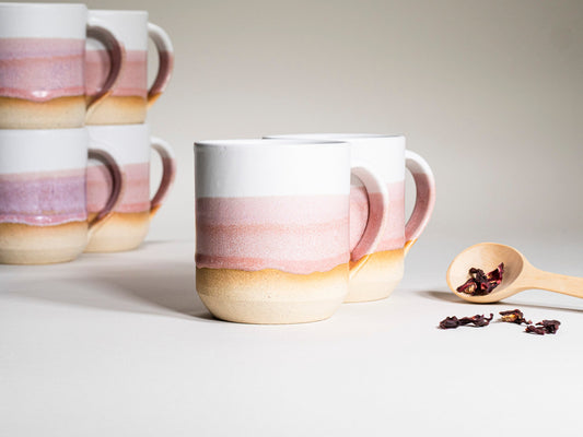 Pink and white striped ceramic mug with curved handle, stoneware glaze