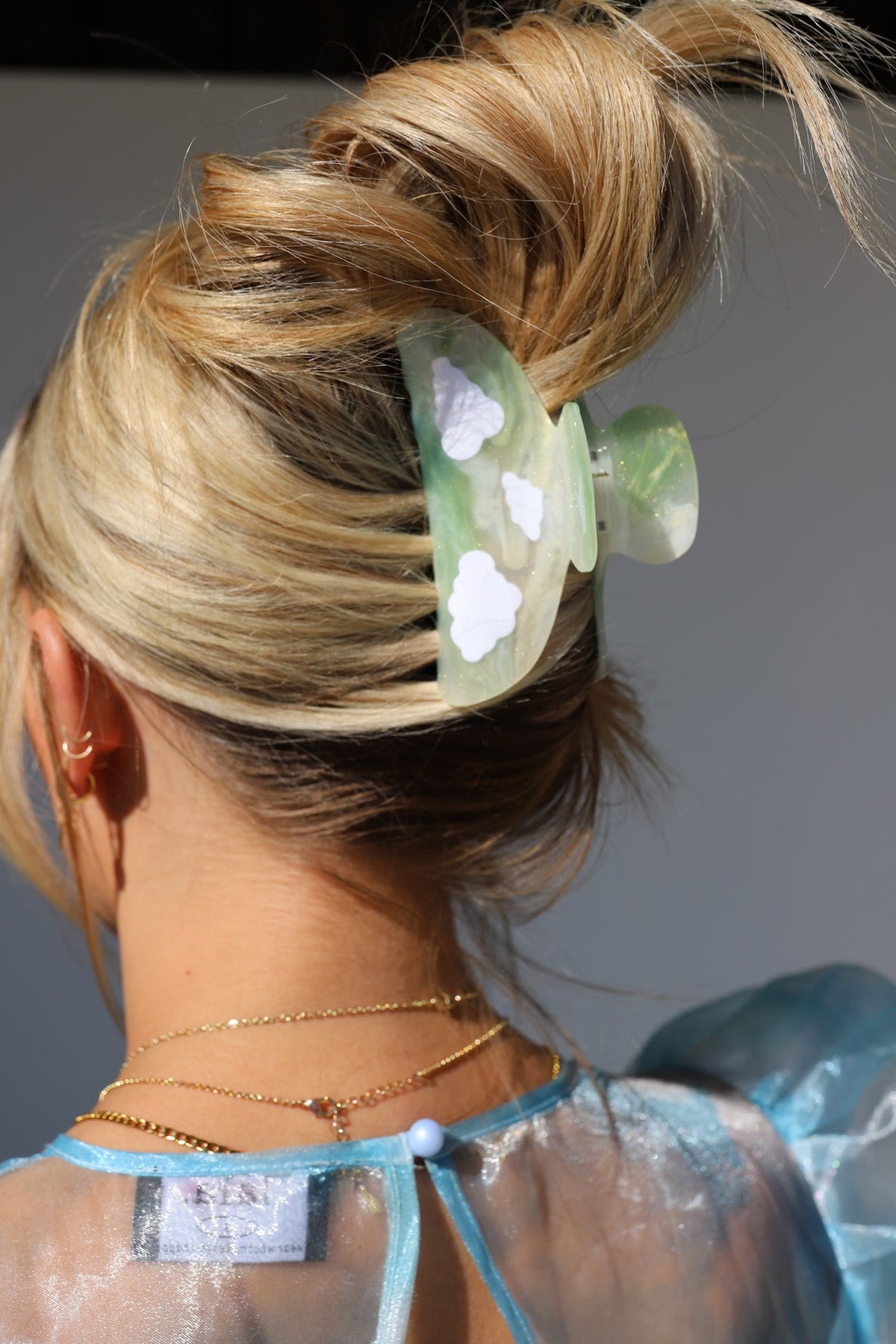 Green translucent floral hair claw clip with white petal-like details