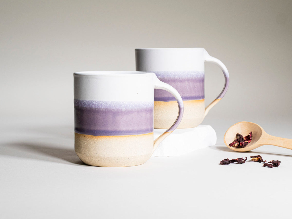 Pair of purple and white ceramic coffee mugs with handles, 14 oz each, banded design.