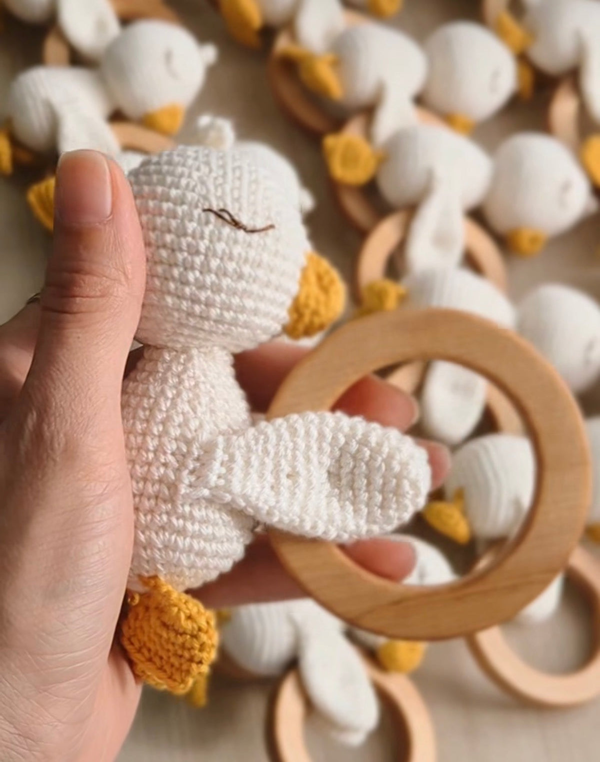 Crochet baby goose rattle with wooden teether ring, cream and tan