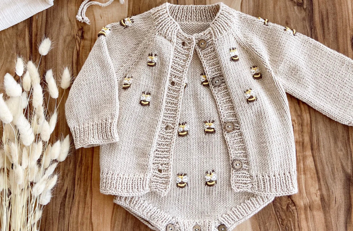 Light beige knit baby romper with button-front cardigan set, bee appliques