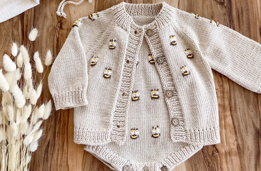 Light beige knit baby romper with button-front cardigan set, bee appliques