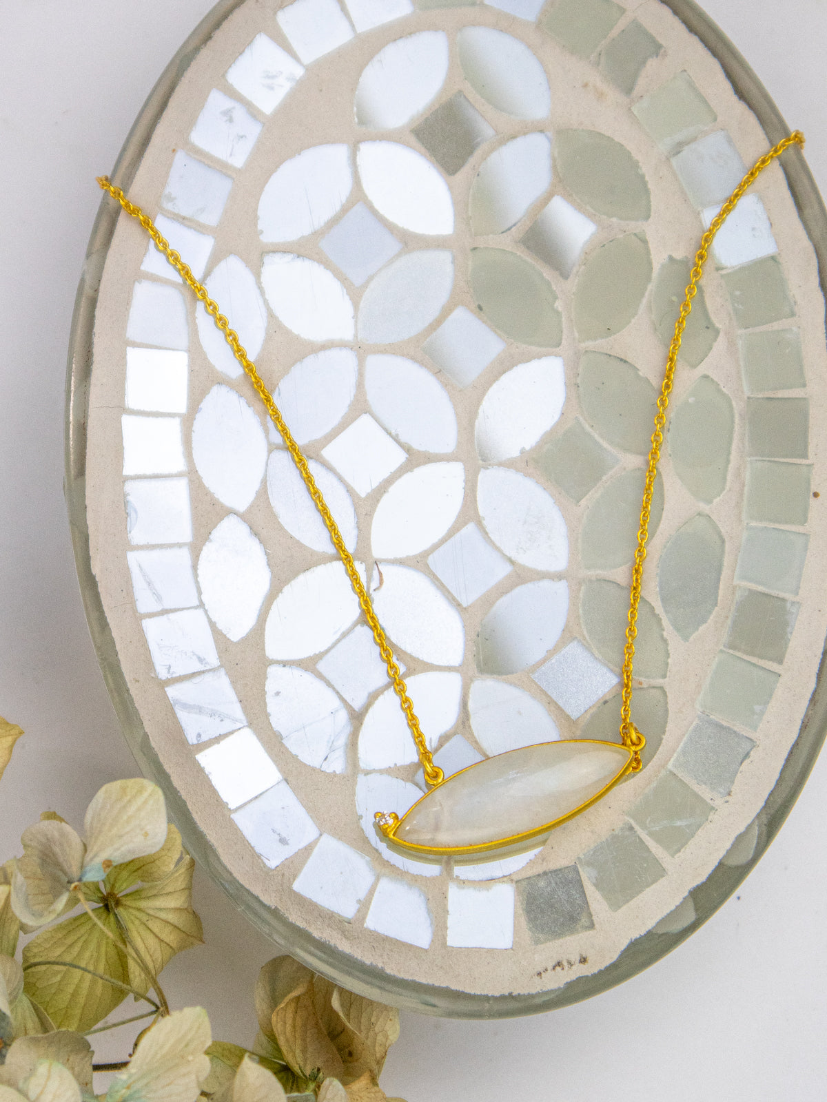 Gold chain necklace with teardrop pale stone pendant