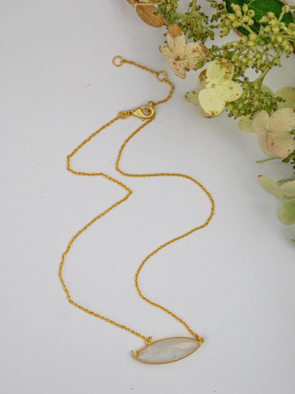 Gold chain necklace with two oval pale stone pendants