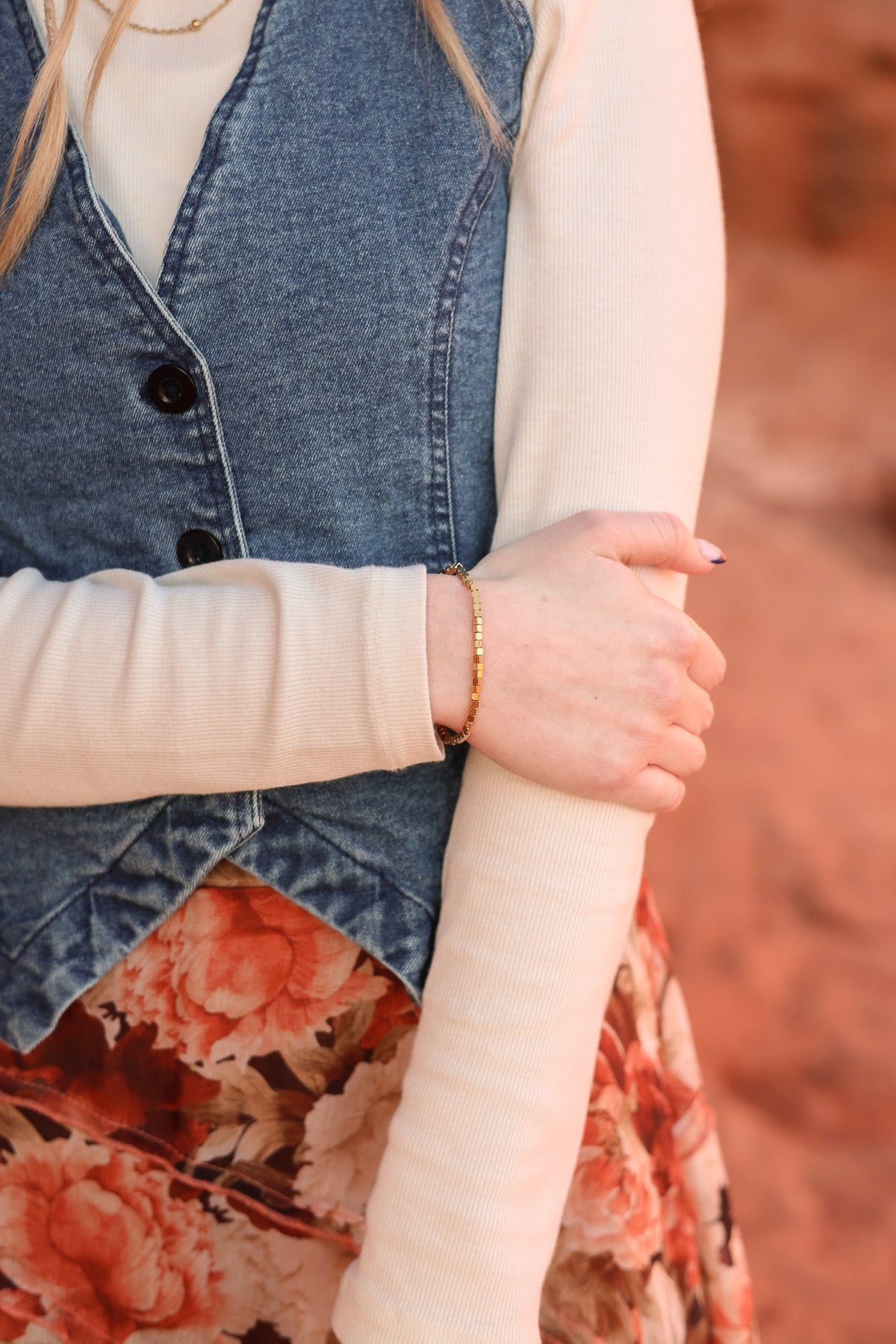 Gold Ember bracelet with square beads worn on the wrist