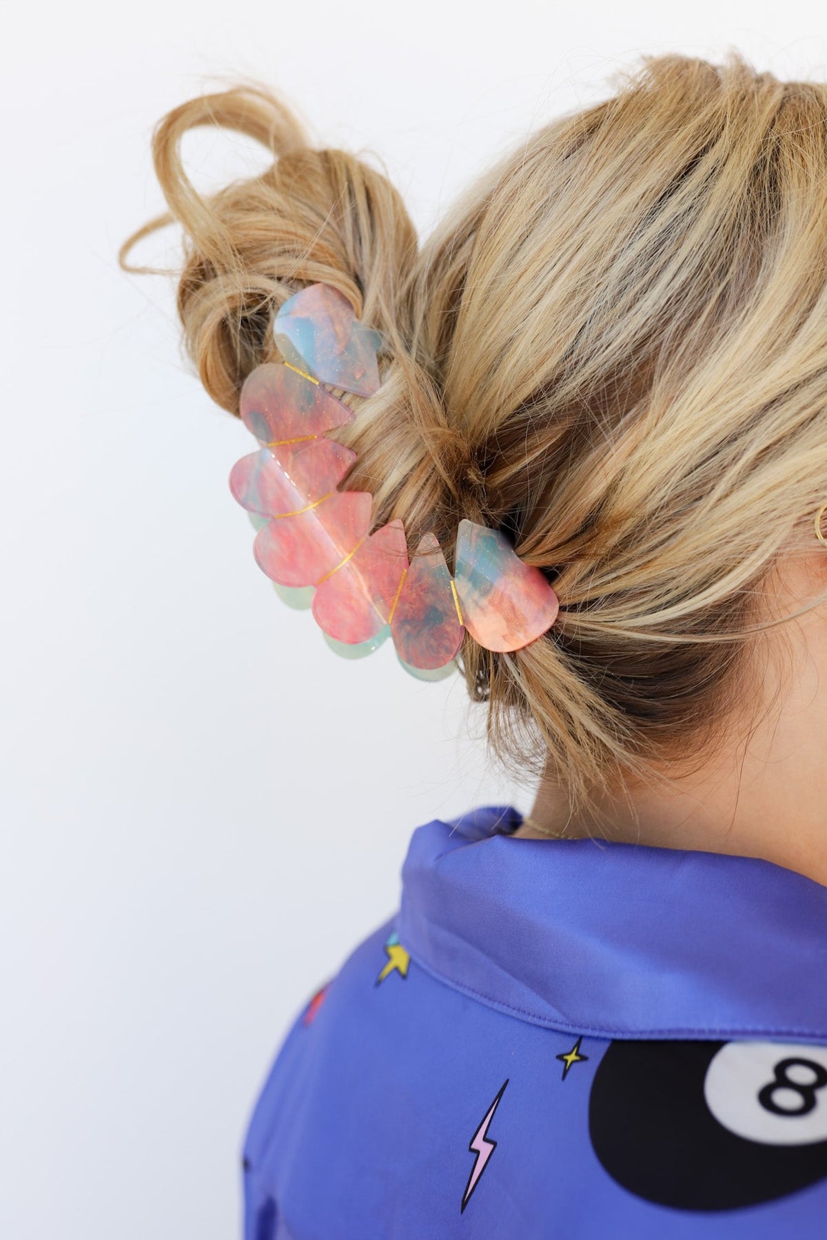 Translucent pastel hair claw clip on blonde ponytail, side view