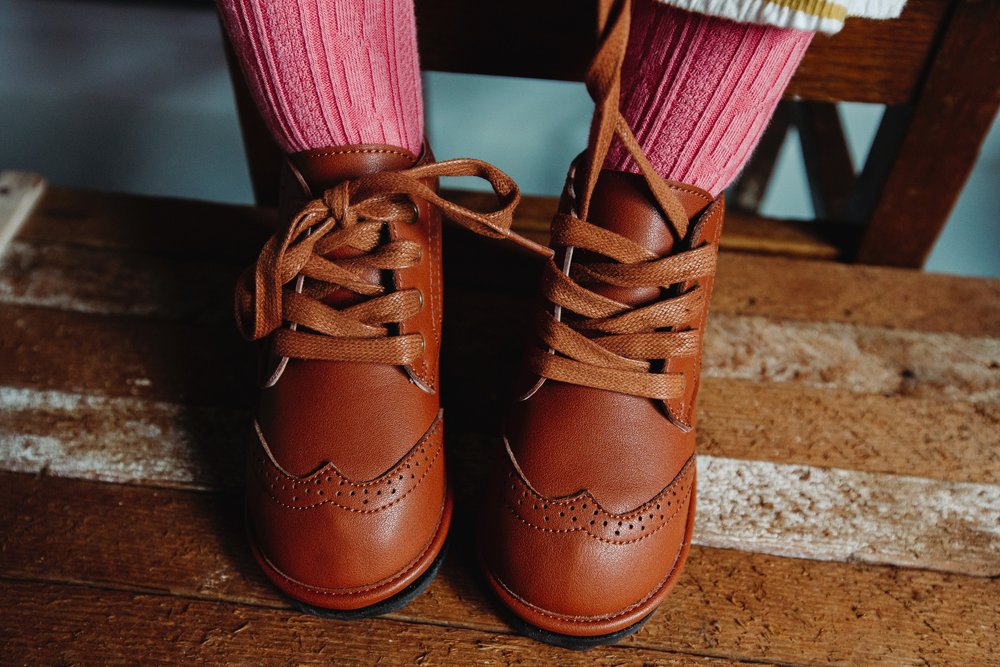 Kids waterproof hand-stitched boots in chestnut, lace-up design.