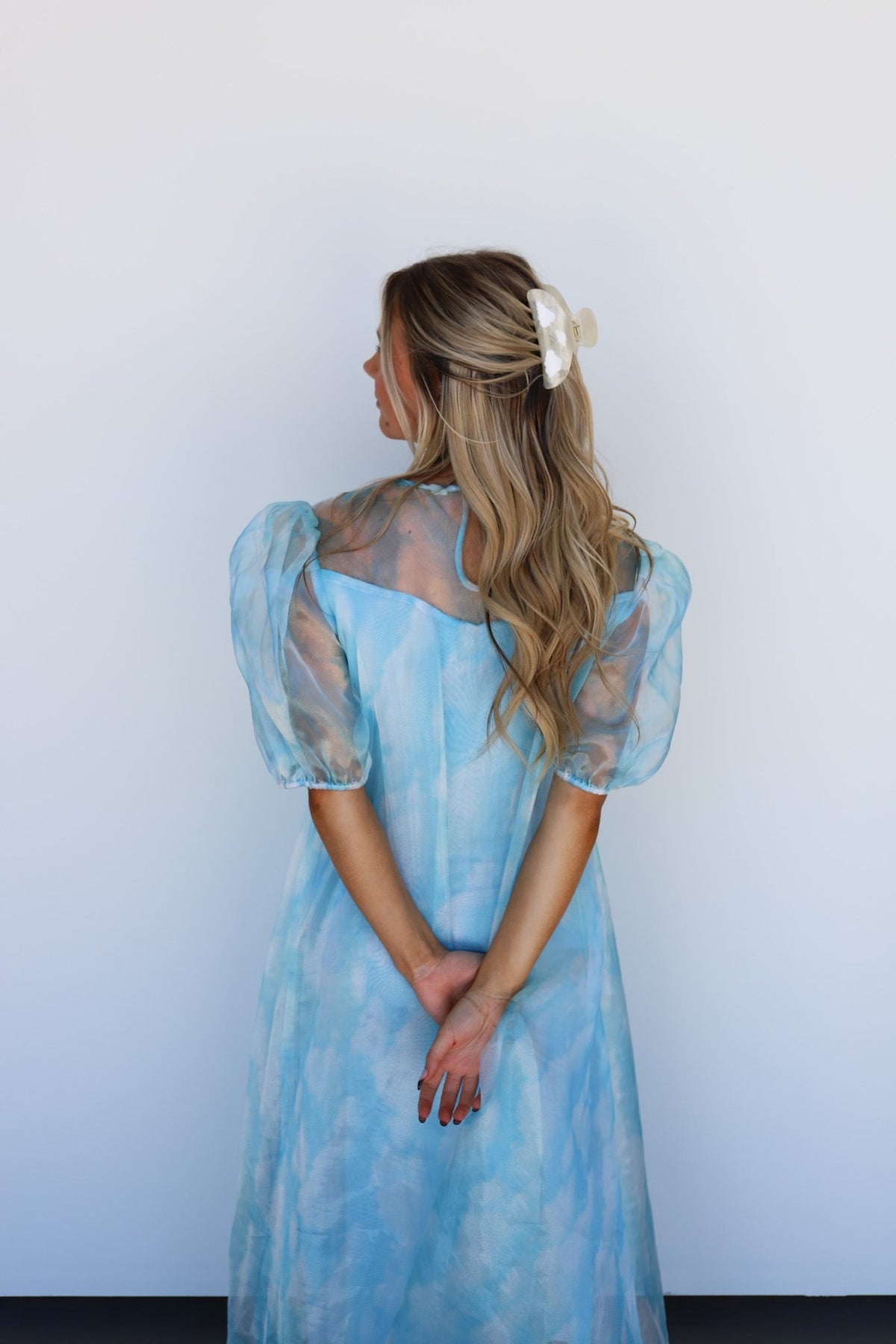 Light blue puff-sleeve dress with white heart hair claw clip in updo