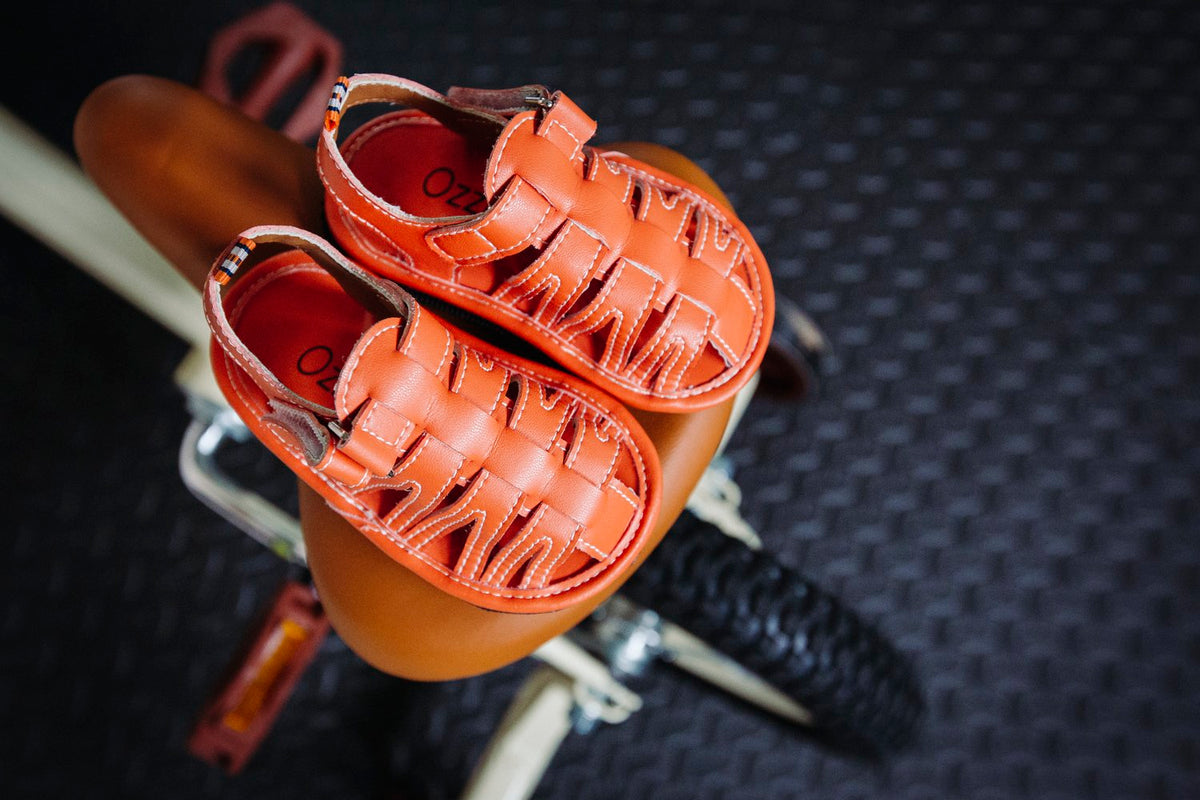 Kids orange barefoot sport sandals with hook-and-loop ankle strap and cutout vamp