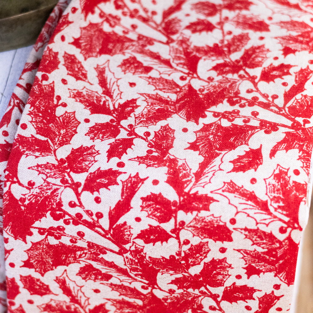 Red botanical print holiday towel fabric close-up