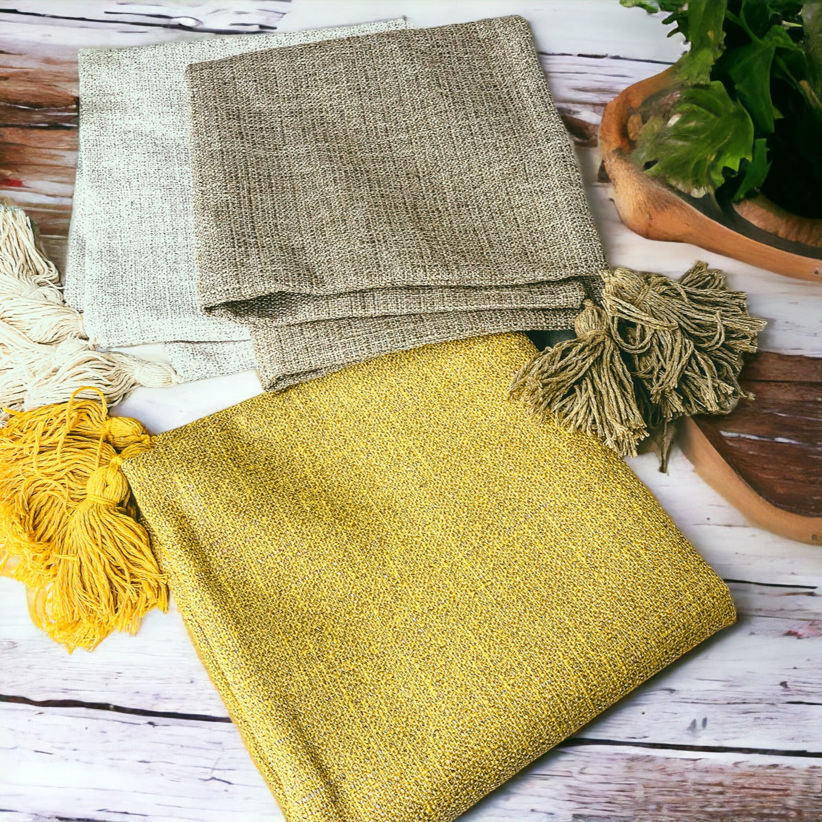 Linen-look pillow cases in gray and yellow with tassel fringe at corners