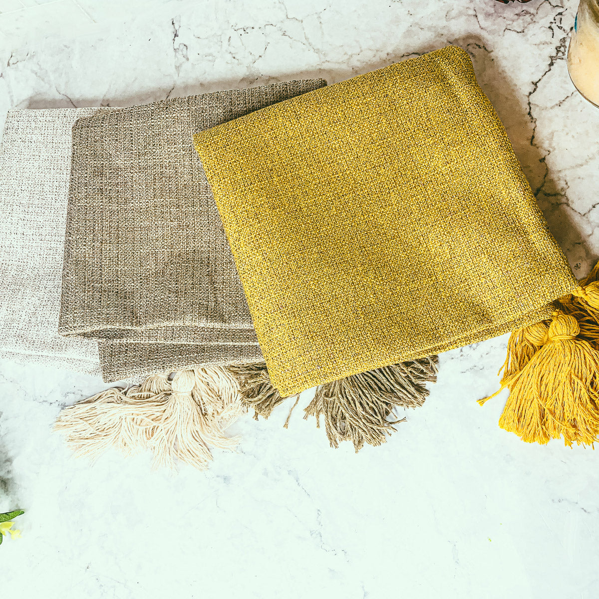 Boho cottage pillow case in gold yellow with fringed tassels at corners.