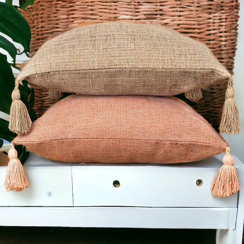 Square linen-look pillow cases in peach and taupe with tasseled fringe