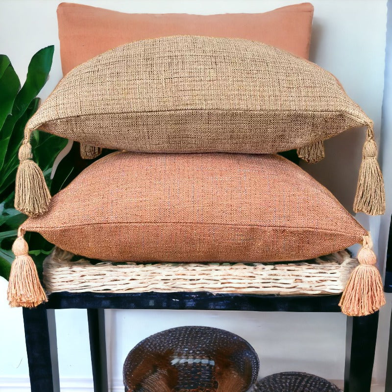 Square linen-look pillow cases in peach and taupe with long tassel fringe