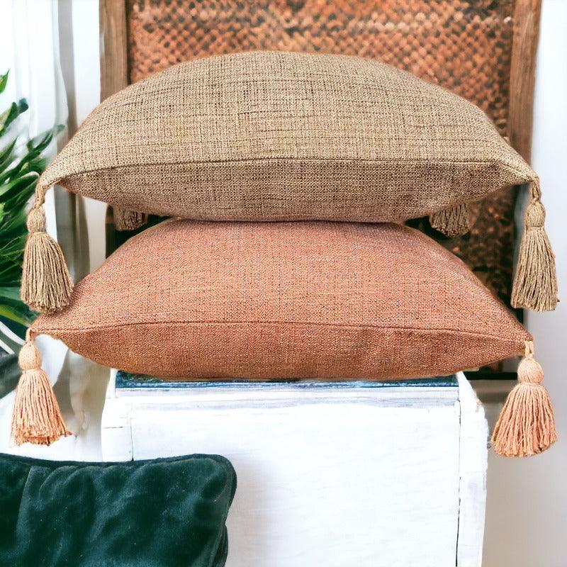Boho-style pillow cover set with taupe and dusty pink fabric, fringe tassel edges