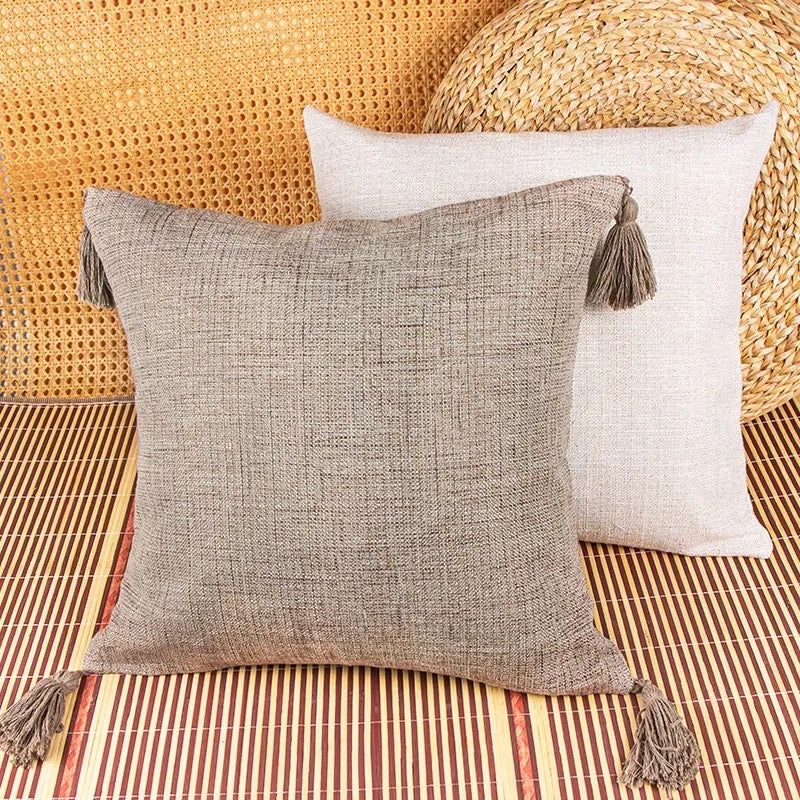 Boho cottage pillow cases in gray and white with tassel accents.