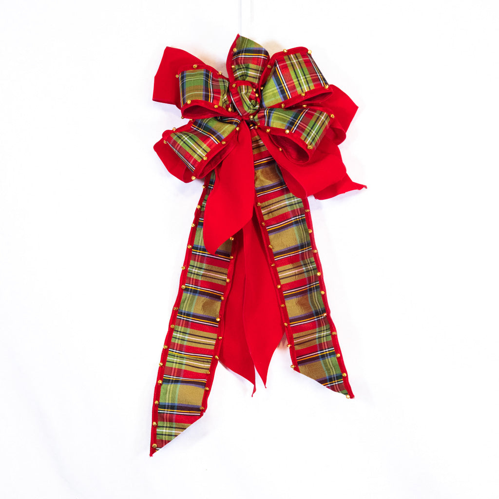 Red plaid ribbon bow with bell-edged ends and gold stud accents