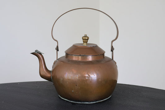 Brass and copper kettle with domed lid, curved spout, and arched side handles