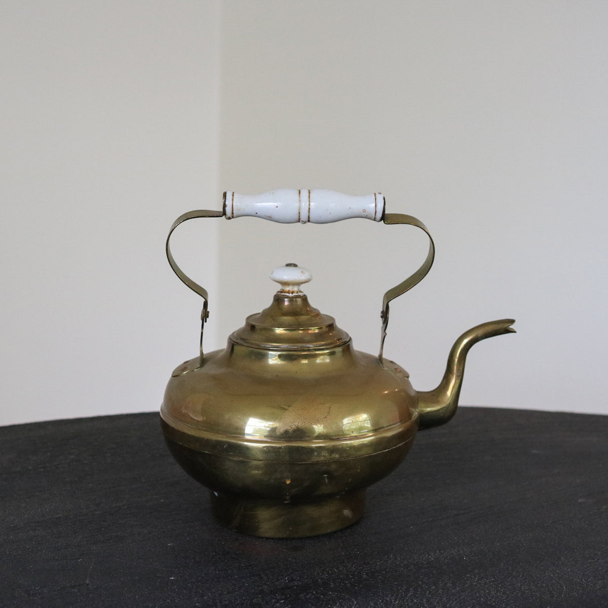 Brass and copper kettle with white insulated handle covers and domed lid