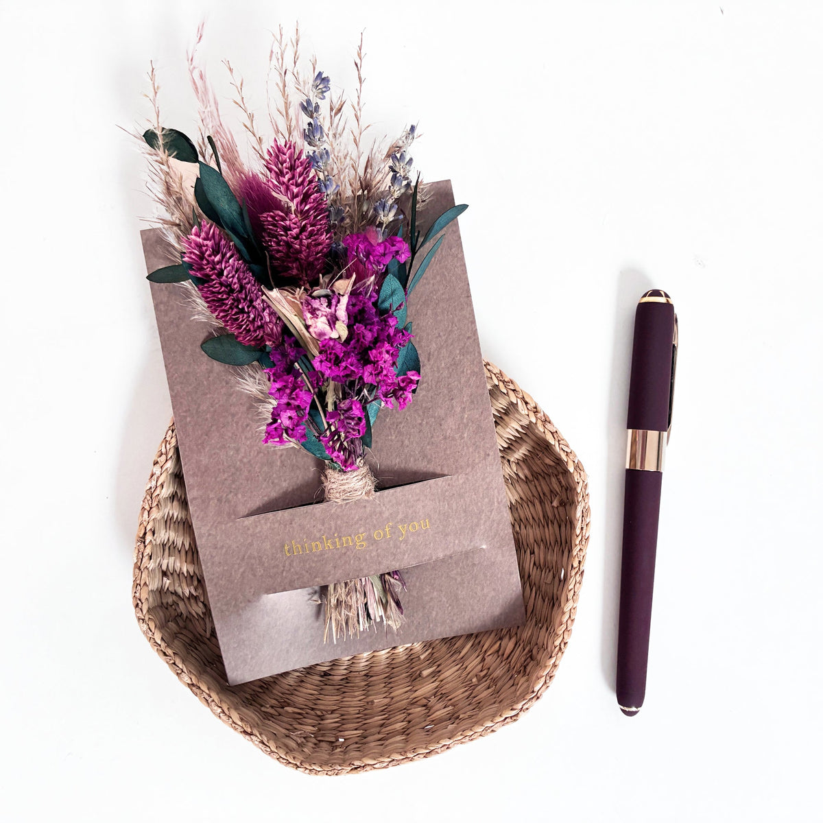 Mini dried floral greeting card with purple bouquet and “thinking of you” on kraft paper
