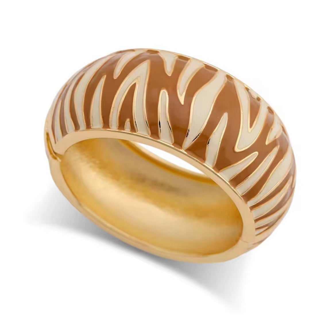 Gold-tone zebra pattern cuff bracelet with wide band and hinged opening