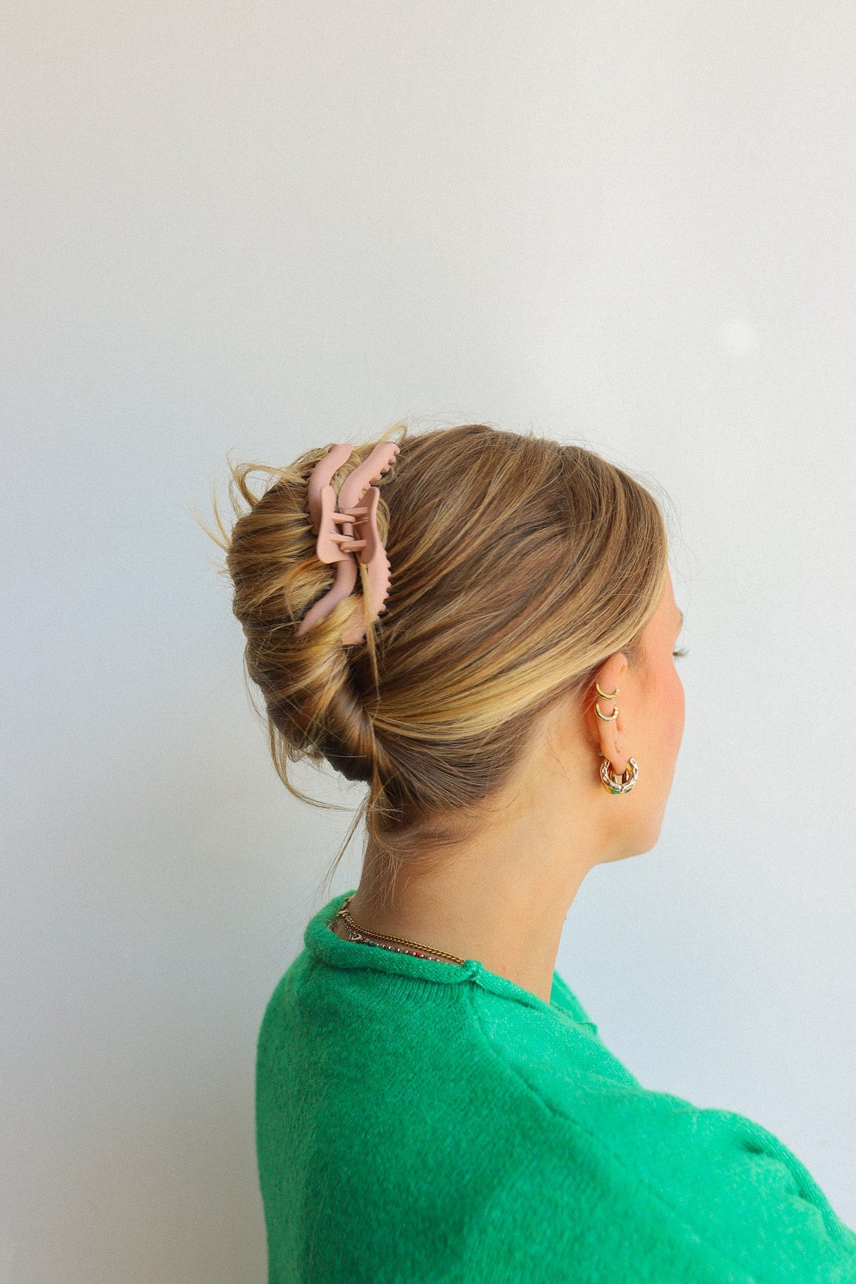 Wavy hold-them hair claw securing a bun on light brown hair
