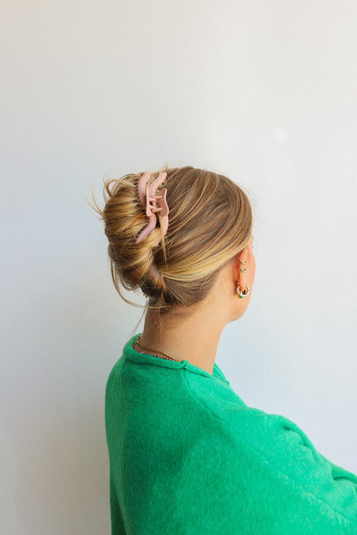Wavy hold-them hair claw securing a bun on light brown hair