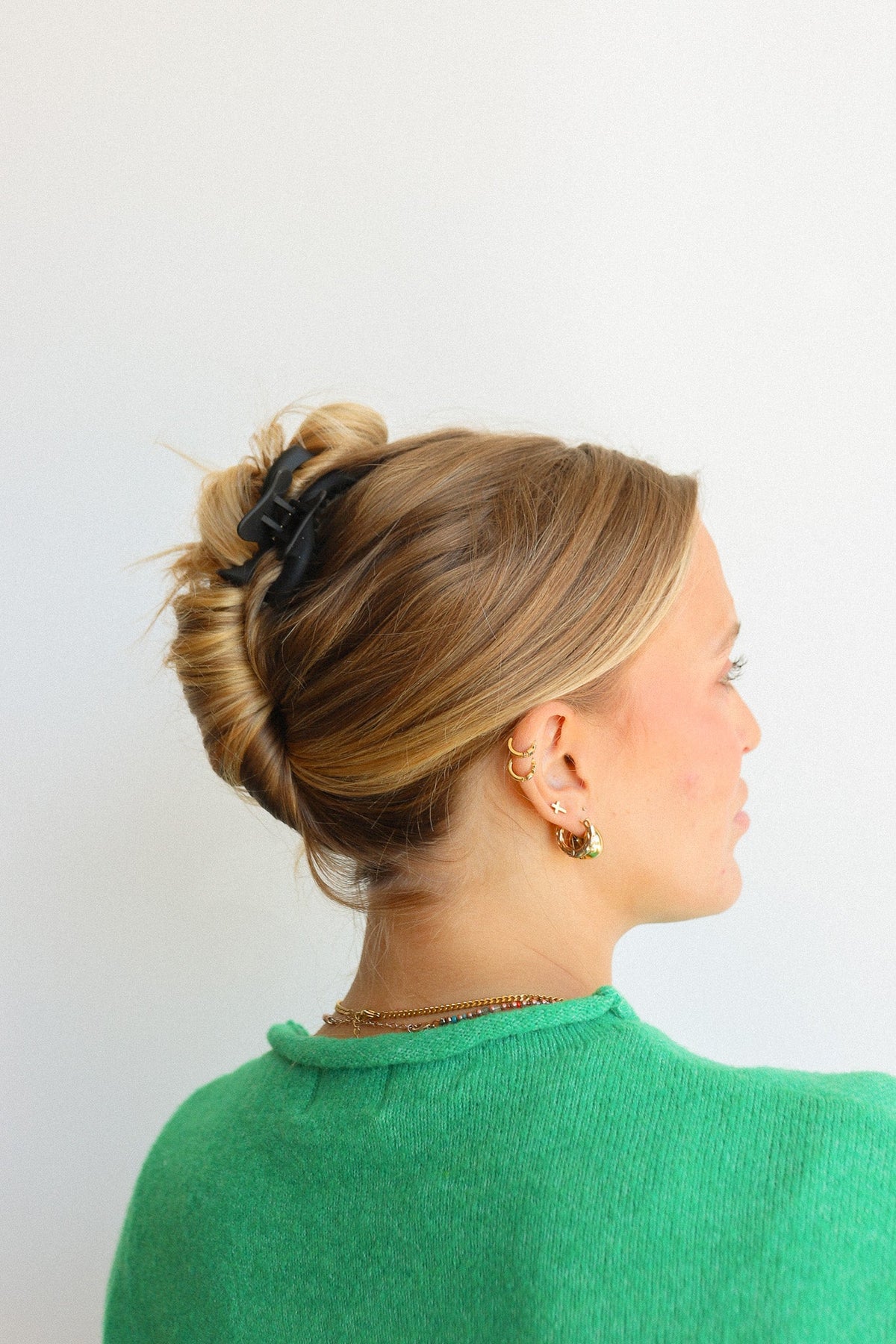 Black wavy mini hair claw on a blonde updo, side view