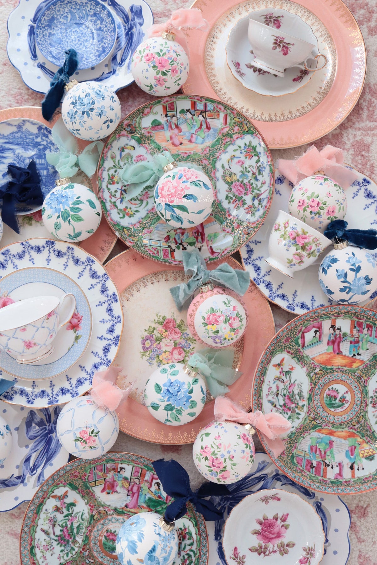 Hand-painted floral ornaments with pink roses, blue flowers, and green leaves
