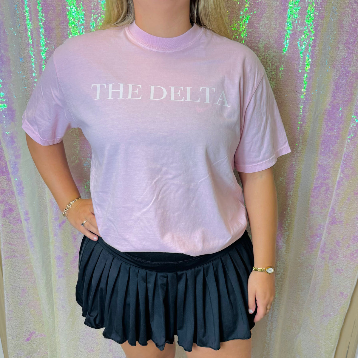 Lavender crew-neck graphic T-shirt with white “THE DELTA” text on the chest.