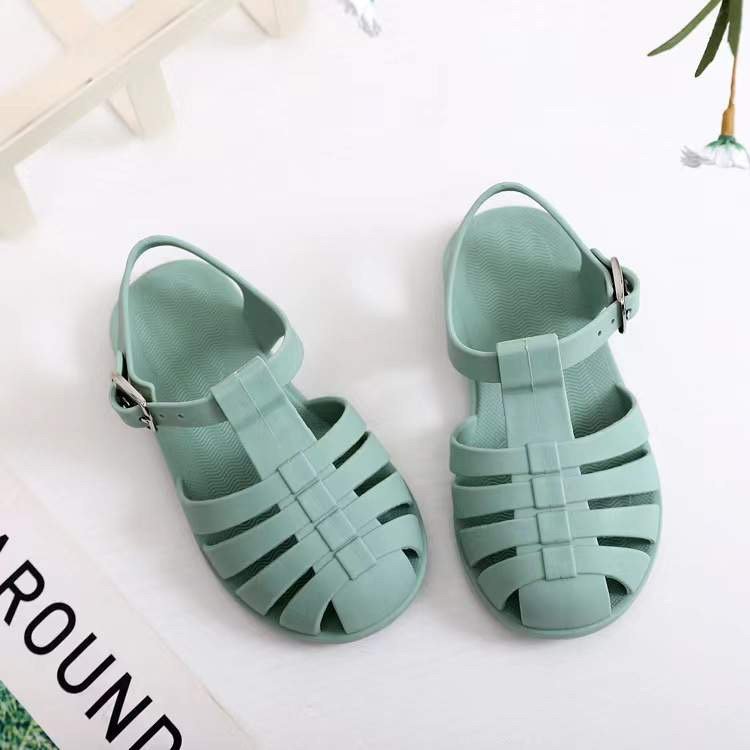 Kids' mint green jelly sandals with buckled ankle strap and wide toe box