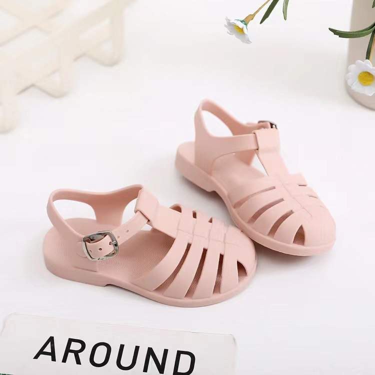 Kids' pink blush jelly sandals with buckled ankle strap and open toe