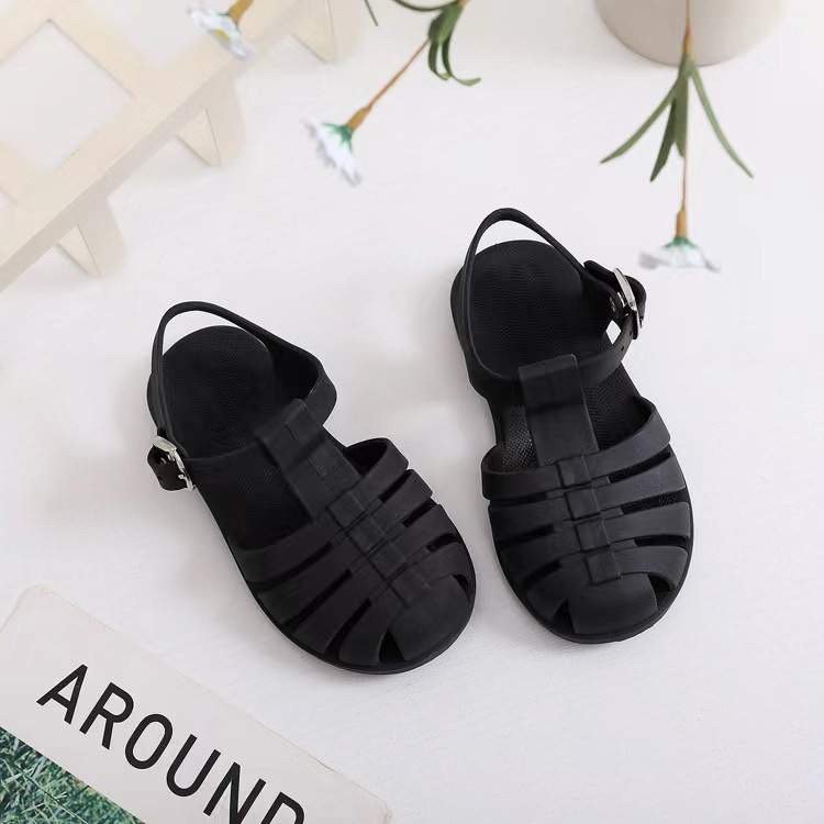 Kids' barefoot jelly sandals in black with adjustable strap and open toe
