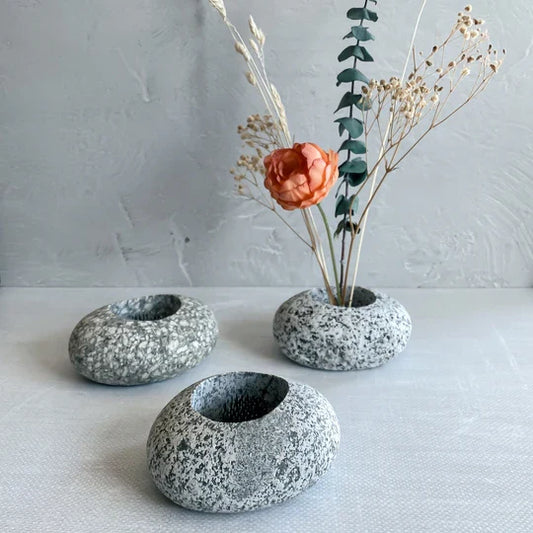 Three speckled stone ikebana vases with round bowl openings for stems