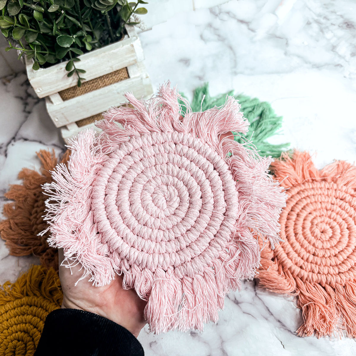 Round braided rope coaster set with pink and coral tassels, spiral weave