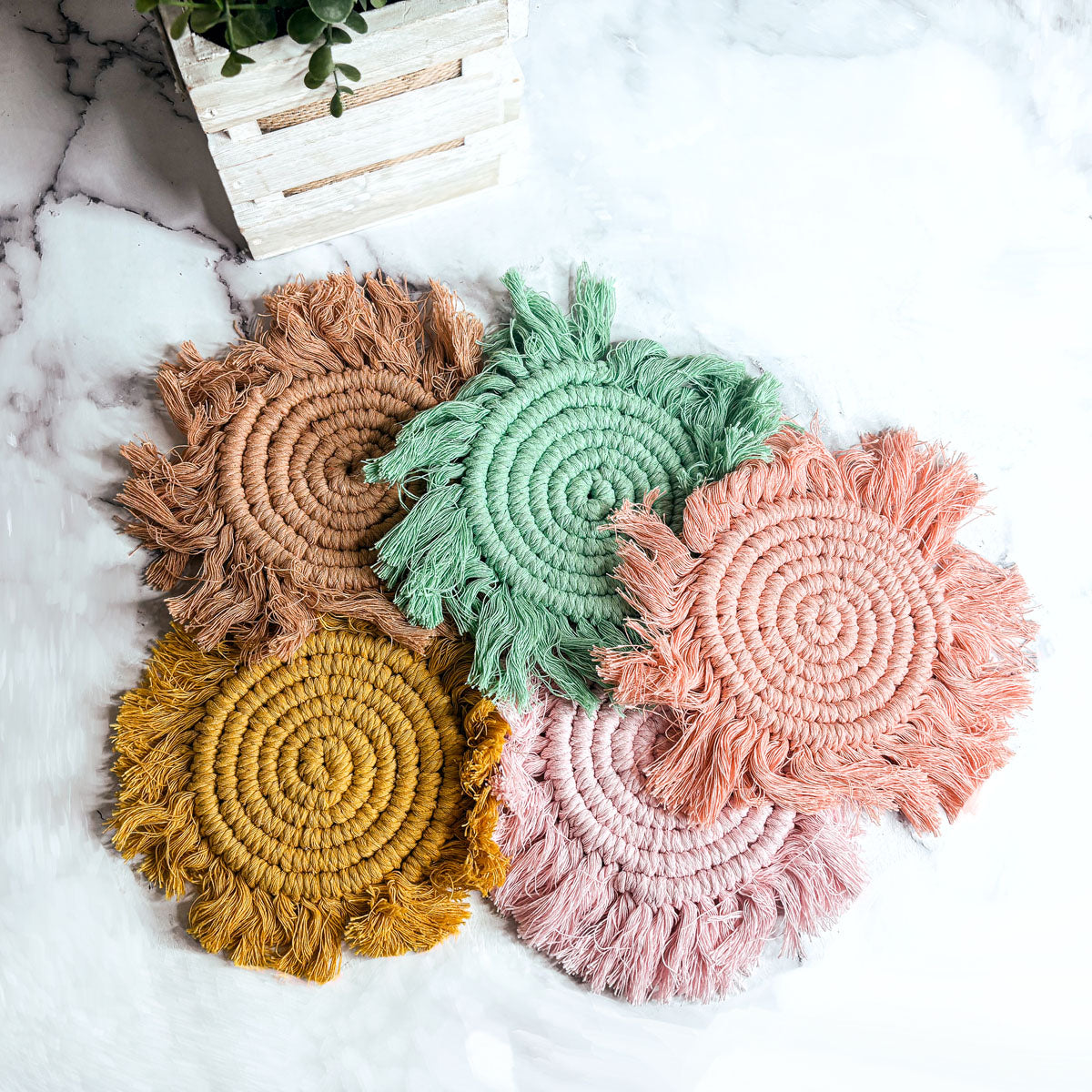 Braided rope tassel coasters set: brown, green, yellow, pink with braided spiral and fringe