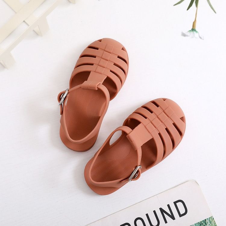 Kids' barefoot jelly sandals in rust with adjustable strap and vented sole