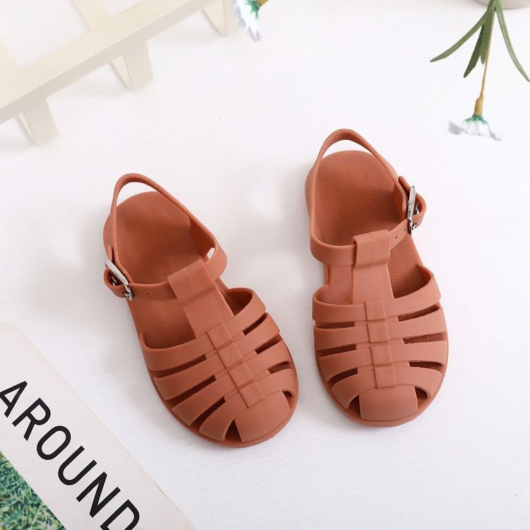 Kids' barefoot jelly sandals in rust with double straps and silver buckle