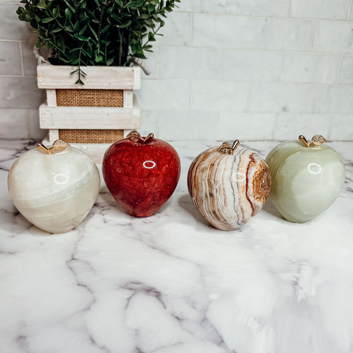 Heart-shaped paperweight set in four colors: white, red, brown marbled, and light green.