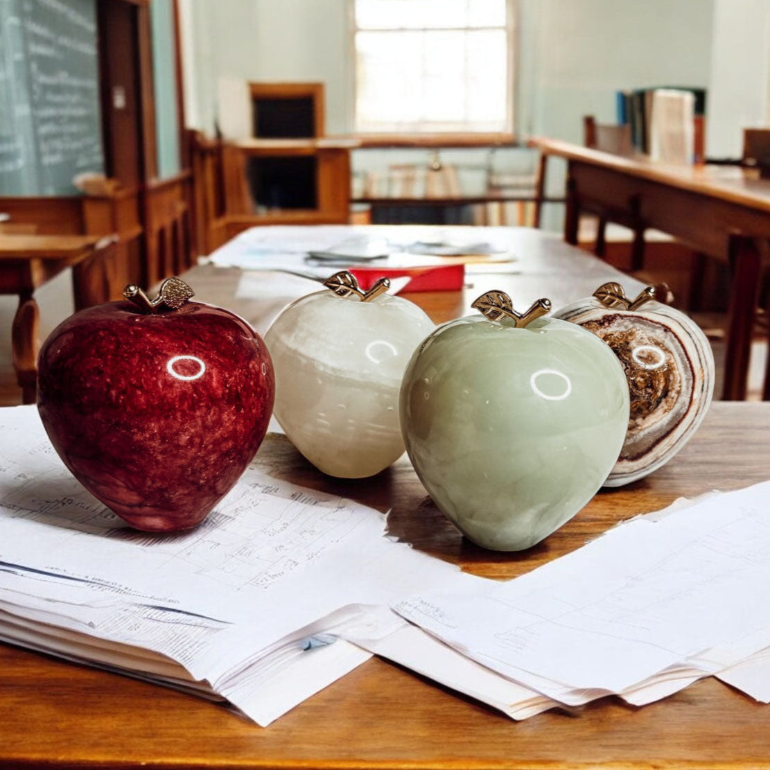 Set of heart-shaped stone apple paperweights with gold-tone clasps in red, white, and green