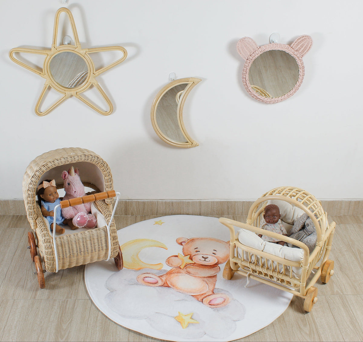 Pink rattan teddy bear wall mirror displayed with star and moon mirrors